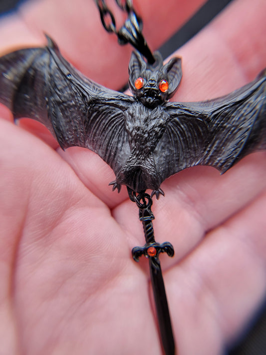 Goth Black Resin Bat Pendant Necklace with Red Eyes and Dangling Black Dagger Charm with Red Accents