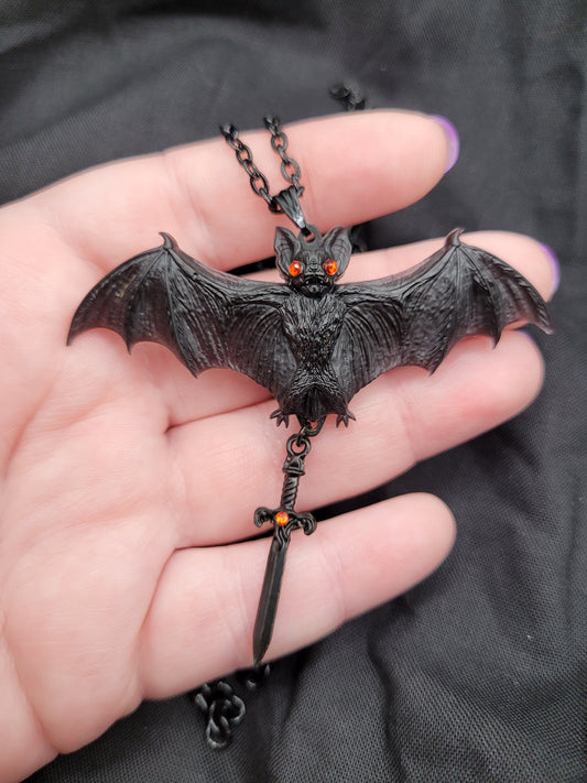 Goth Black Resin Bat Pendant Necklace with Red Eyes and Dangling Black Dagger Charm with Red Accents