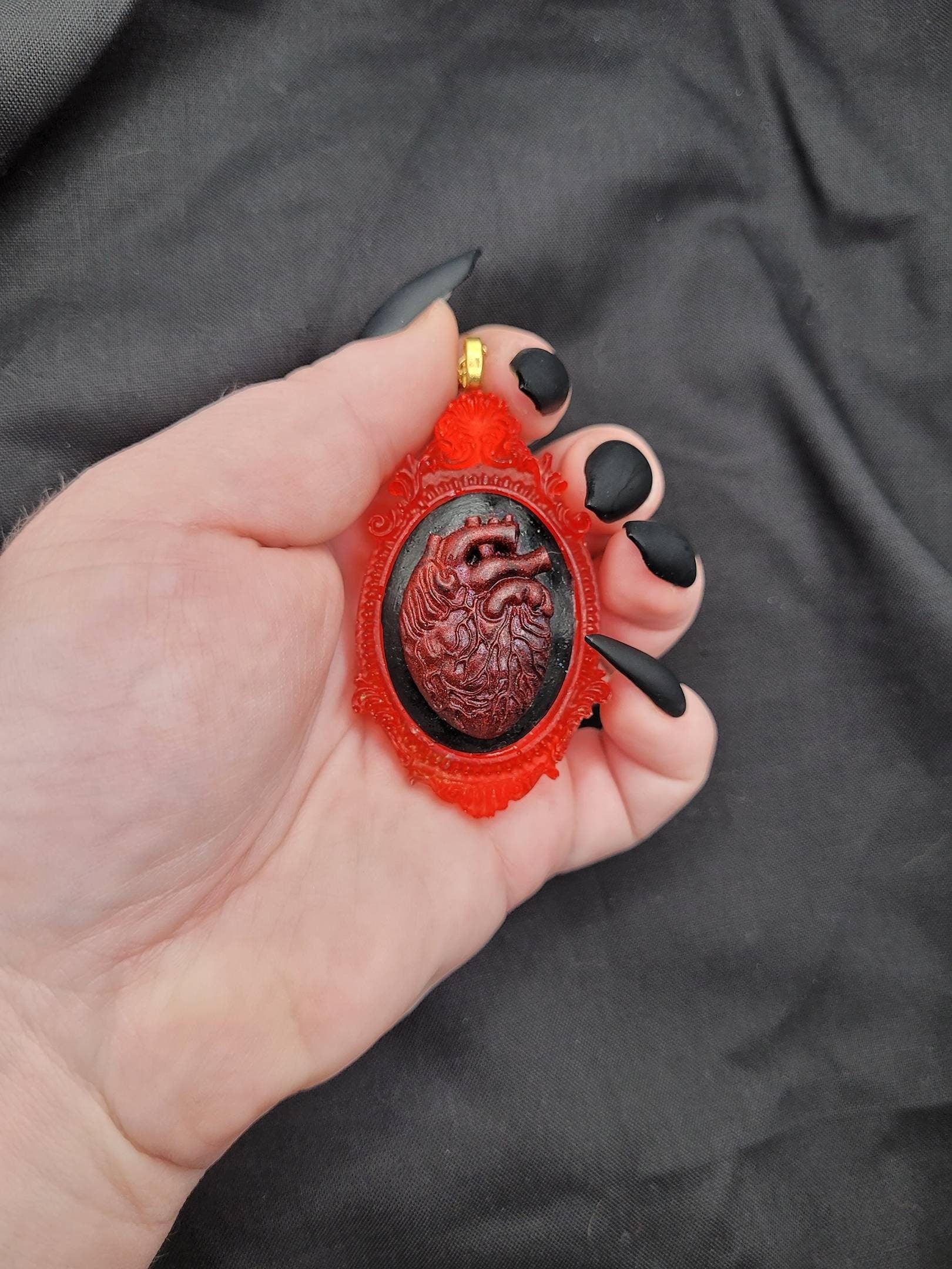 Gothic Red Anatomical Heart Cameo on Black Background with Translucent Red Bezel and Gold Chain